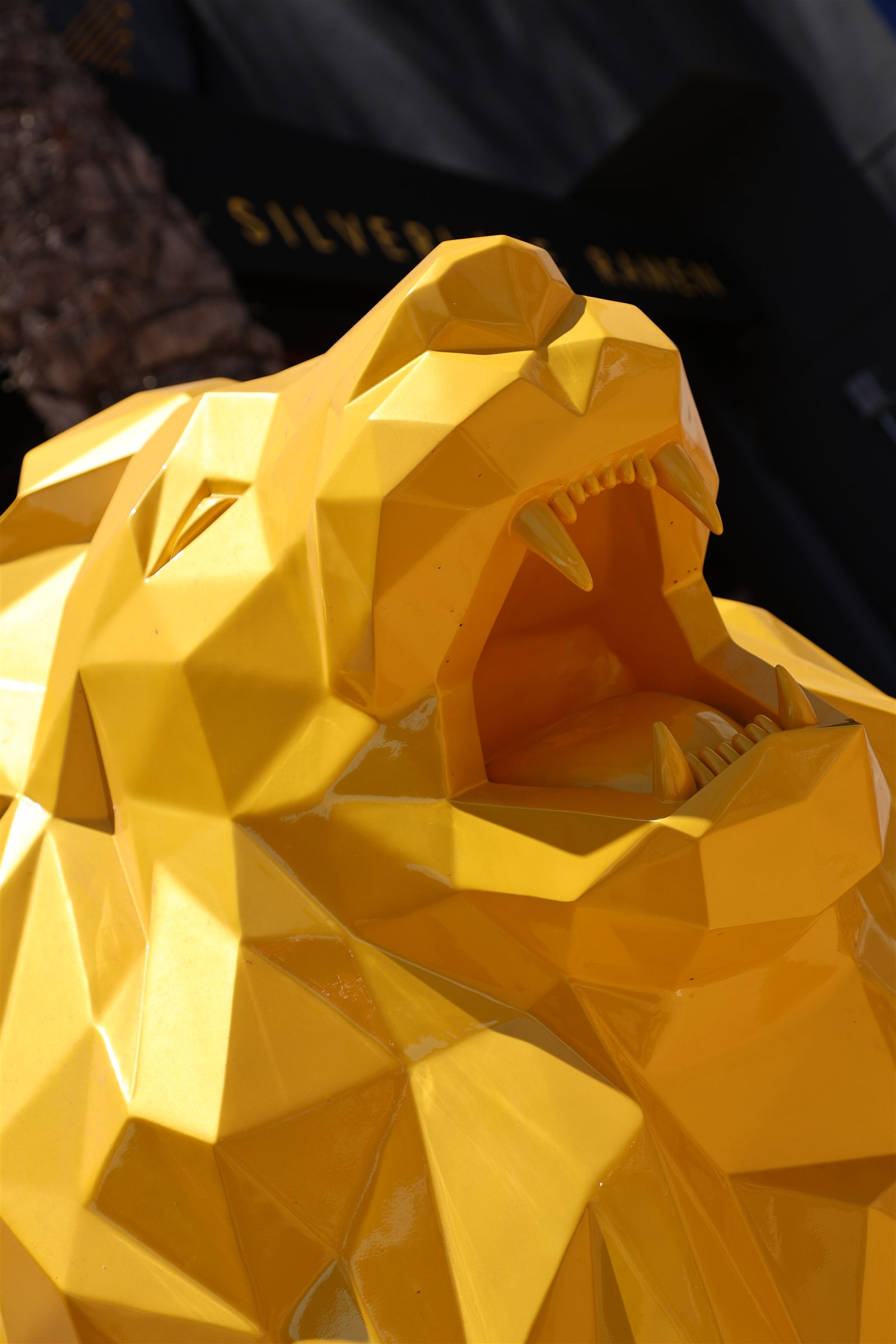 Close-up of yellow lion sculpture by Richard Orlinski
